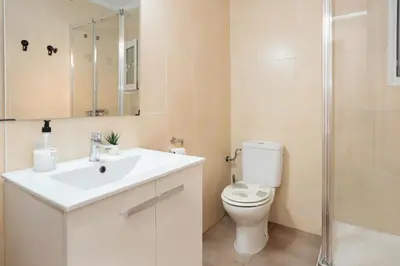 a small bathroom with a washing machine and a washer at Habitaciones con baño compartido en bonito Apartamento en Badalona in Badalona