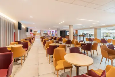 a dining room with tables and chairs at FERGUS Club Pineda Splash in Pineda de Mar