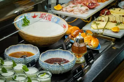 a buffet of food with bowls and other foods at Hotel del Mar in Barcelona
