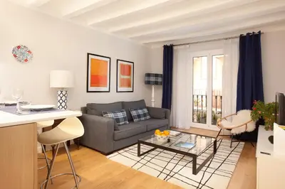 a living room with a couch and a table at Click&Flat Stylish Torrijos in Barcelona