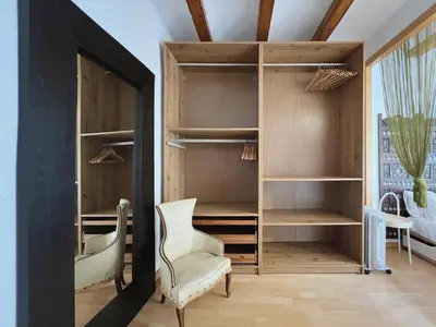 a room with a closet with a chair and a mirror at Stay U-nique Apartments Murillo in Barcelona