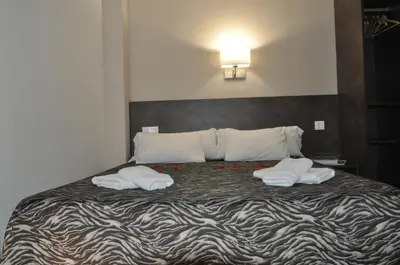 a bedroom with a bed with two towels on it at Aparthotel Safari in Calella