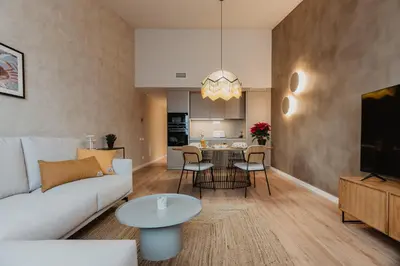 a living room with a couch and a table at Petit Luxe Volta ÀTIC in Terrassa
