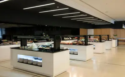 a buffet line in a restaurant with food on display at Barceló Sants in Barcelona