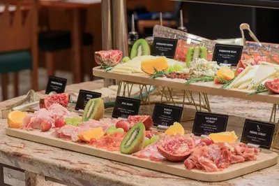 a display of meats and vegetables on a table at Hotel Gótico in Barcelona