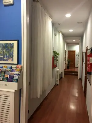 a hallway with a white curtain and a hallway with a hallway at Hotel Pelayo in Barcelona