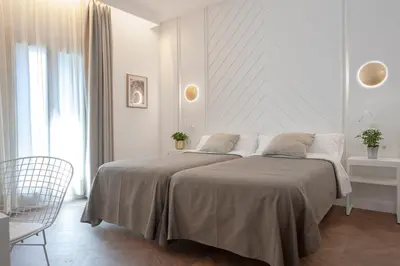 a white bedroom with a large bed in a room at Gaudi Hotel in Barcelona