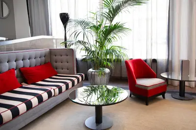 a living room with a couch and a chair and a table at Pestana Arena Barcelona in Barcelona