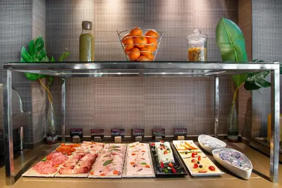 a display case with many different types of food at Pestana Arena Barcelona in Barcelona