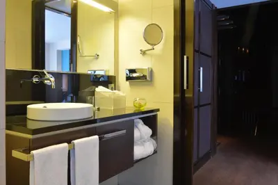 a bathroom with a sink and a mirror at Pestana Arena Barcelona in Barcelona