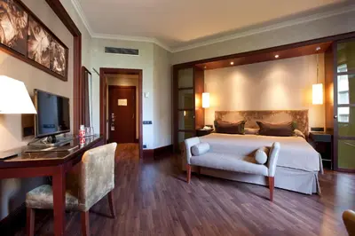 a bedroom with a bed and a desk and a television at Hotel Barcelona Center in Barcelona