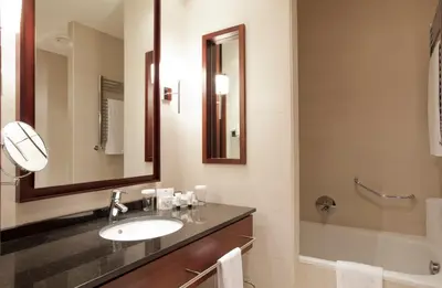 a bathroom with a sink and a mirror and a tub at Hotel Barcelona Center in Barcelona