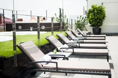 a row of chaise lounges on a balcony at Hotel Barcelona Center in Barcelona
