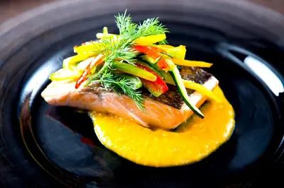 a plate of food with fish and vegetables on it at Hotel Barcelona Center in Barcelona