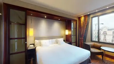 a bedroom with a large white bed and a window at Hotel Barcelona Center in Barcelona