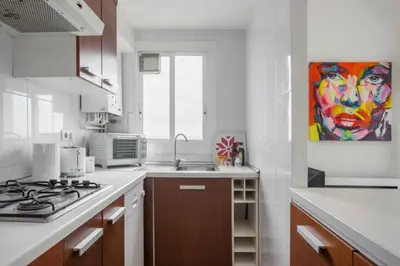 a kitchen with a sink and a painting on the wall at Sunset Boutique Castelldefels by MyRentalHost in Castelldefels