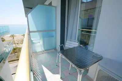 a bedroom with a large bed and a large window at Hotel Internacional in Calella