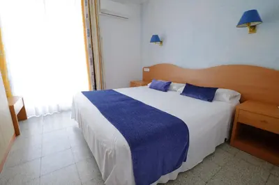 a balcony with two chairs and a view of the beach at Hotel Internacional in Calella