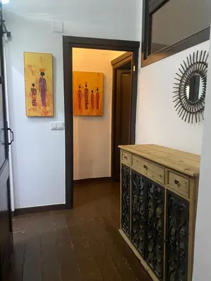 a room with a counter and a mirror on the wall at Cal Castlà in La Granada