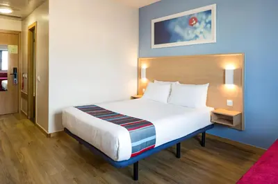 a bedroom with a large bed in a hotel room at Travelodge Barcelona Fira in Hospitalet de Llobregat