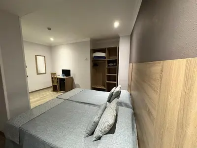 a bedroom with a bed with two pillows on it at Ramblas Hotel in Barcelona