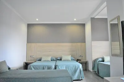 a hotel room with two beds and a couch at Ramblas Hotel in Barcelona