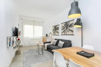 a living room with a table and a couch at Click&Flat Rizal in Barcelona