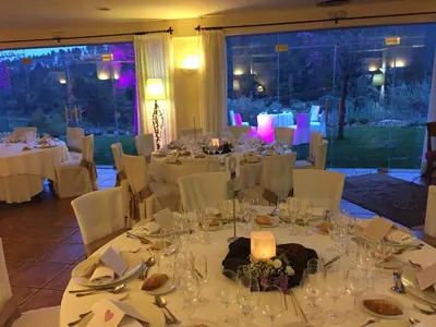 a dining room with white tables and white chairs at Hotel Golf Can Rafel in Corbera de Llobregat