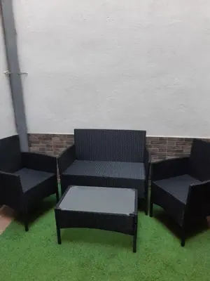 three chairs and a coffee table in a room at Lucky House in Badalona