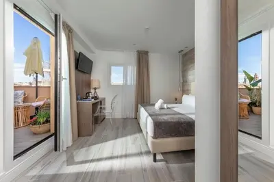 a hotel room with a bed and a balcony at Hotel Oasis in Barcelona