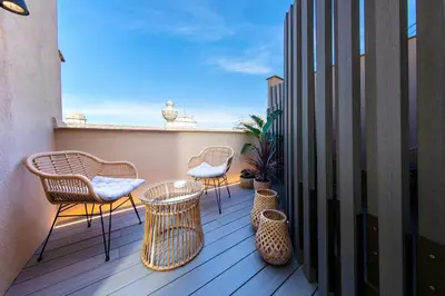 a balcony with chairs and tables on a balcony at Hotel Oasis in Barcelona