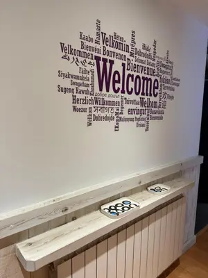 a welcome wall with a welcome sign on it at La Llum de Sitges in Sitges