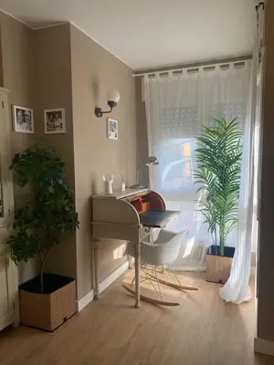 a room with a desk and a window with plants at Cardedeu City and Circuit apartment in Cardedeu