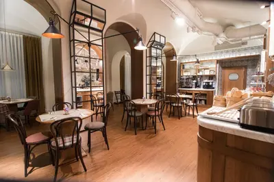 a restaurant with tables and chairs and a bar at Petit Palace Boqueria Garden in Barcelona