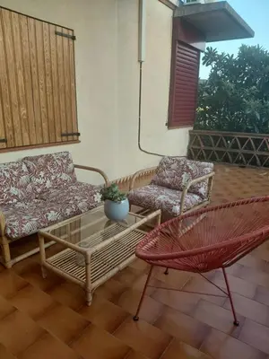 a patio with a couch and a table and a chair at Chalet Entre Parques Naturales in Vallgorguina