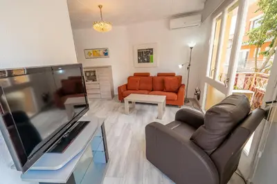a living room with a television and a couch at HomeHolidaysRentals SantMartin - Costa Barcelona in Calella