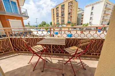 a balcony with two chairs and a table on a balcony at HomeHolidaysRentals SantMartin - Costa Barcelona in Calella