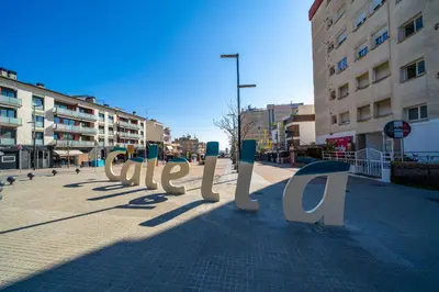 a sign on a sidewalk in a city at HomeHolidaysRentals SantMartin - Costa Barcelona in Calella