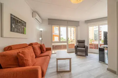 a living room with a couch and a chair at HomeHolidaysRentals SantMartin - Costa Barcelona in Calella