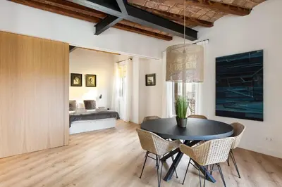 a dining room with a black table and chairs at Enjoy Apartments La Riera One in Barcelona