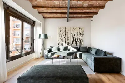 a living room with a couch and a table at Enjoy Apartments La Riera One in Barcelona