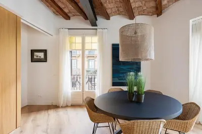 a dining room with a black table and chairs at Enjoy Apartments La Riera One in Barcelona