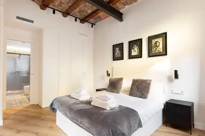 a bedroom with a white bed with towels on it at Enjoy Apartments La Riera One in Barcelona