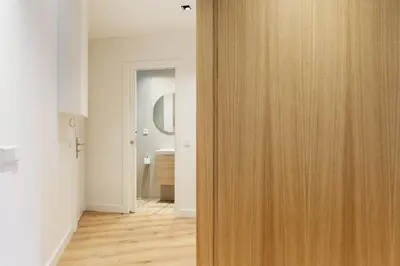 an open wooden door in a room with a hallway at Enjoy Apartments La Riera One in Barcelona