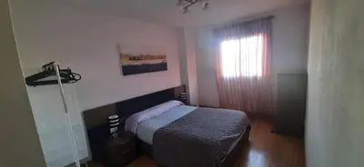 a small bedroom with a bed and a window at Precioso Piso Barcelona in Santa Coloma de Cervelló