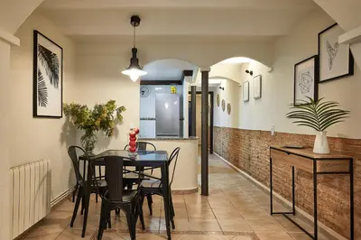 a dining room with a table and chairs at BBarcelona Parallel Apartment in Barcelona