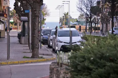 a street with cars parked on the side of the road at Apartamento Sofia in Pineda de Mar