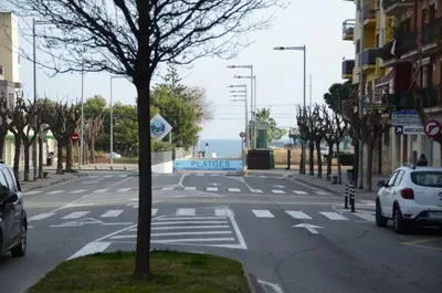 an empty street with cars parked on the road at Apartamento Sofia in Pineda de Mar