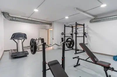 a gym with several equipment in a room at AB North Barcelona Apartments in Santa Coloma