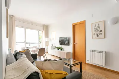 a living room with a couch and a table at AB North Barcelona Apartments in Santa Coloma
